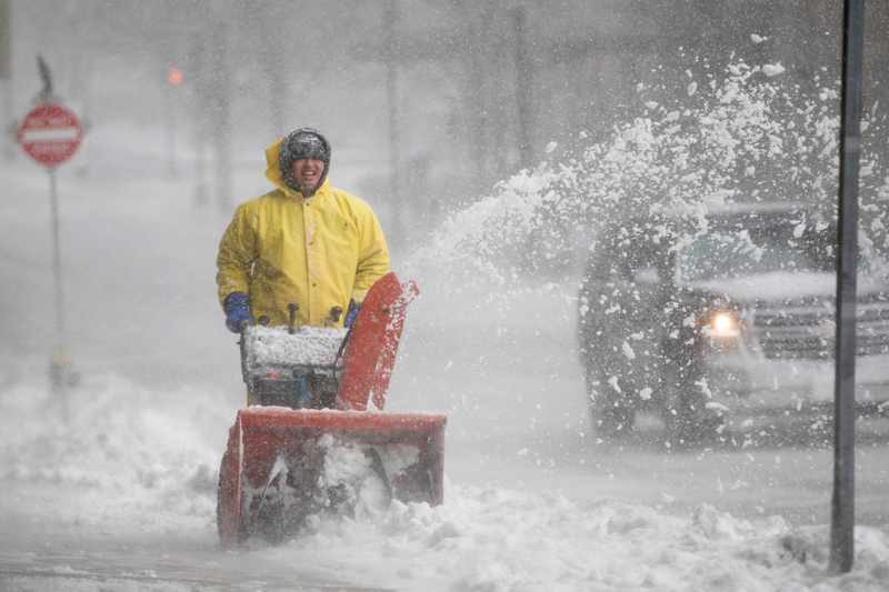 A worker uses a snowblower on Clarendon St. as Winter Storm Skylar bears down on March 13, 2018 in Boston, Massachusetts.